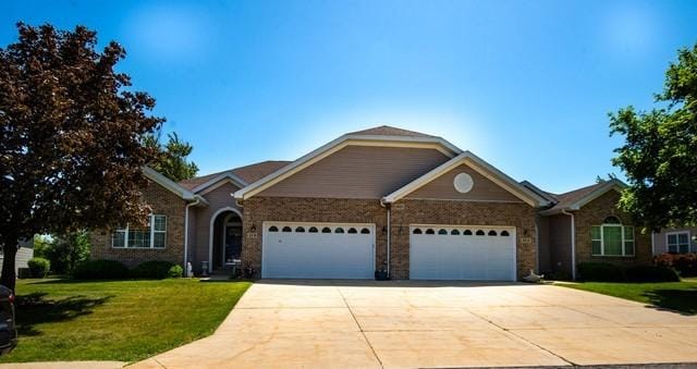 9000 226th Ct Unit 23B, Salem, WI 53168 - ranch-style house featuring a garage, concrete driveway, a front lawn, and stone siding