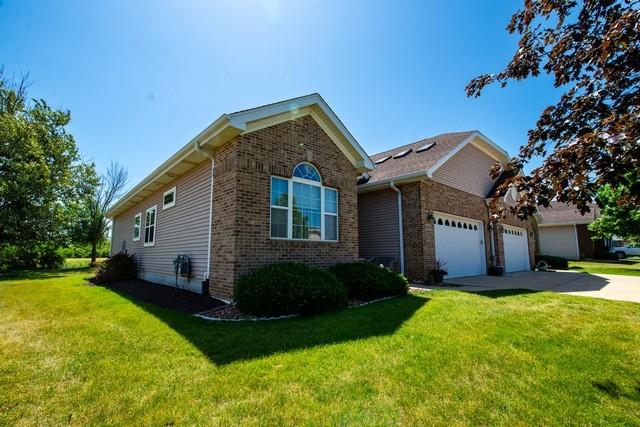 9000 226th Ct Unit 23B, Salem, WI 53168 - view of front of house featuring a garage, driveway, a front lawn, and brick siding
