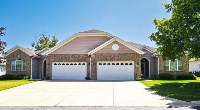 9000 226th Ct Unit 23B, Salem, WI 53168 - ranch-style house featuring a garage, driveway, a front yard, and brick siding