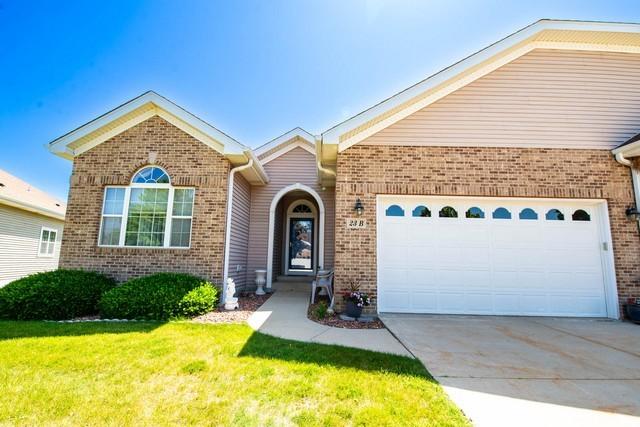 9000 226th Ct Unit 23B, Salem, WI 53168 - view of front of home with brick siding, an attached garage, concrete driveway, and a front yard