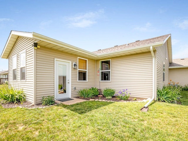 4122 Waters Edge Dr, Belvidere, IL 61008 - back of house featuring a yard and roof with shingles