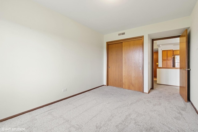 5225 N Riversedge Ter Unit 511, Chicago, IL 60630 - unfurnished bedroom featuring freestanding refrigerator, carpet, and a closet