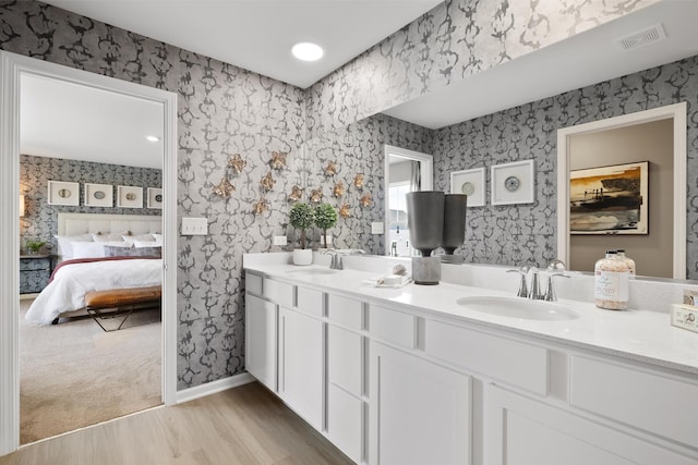 614 Lismore Cir, Elgin, IL 60124 - full bathroom with wallpapered walls, double vanity, ensuite bath, and wood finished floors