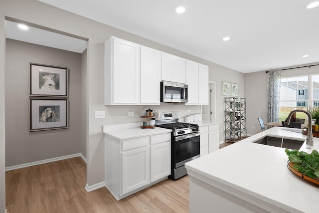 614 Lismore Cir, Elgin, IL 60124 - kitchen with appliances with stainless steel finishes, light wood-style flooring, white cabinetry, recessed lighting, and light stone counters