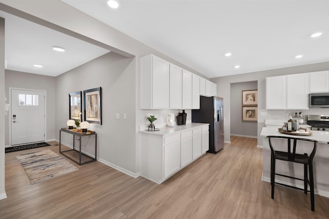 614 Lismore Cir, Elgin, IL 60124 - kitchen featuring appliances with stainless steel finishes, light wood-style flooring, light countertops, white cabinets, and recessed lighting