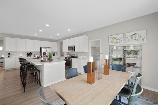 614 Lismore Cir, Elgin, IL 60124 - dining space with light wood-style flooring and recessed lighting