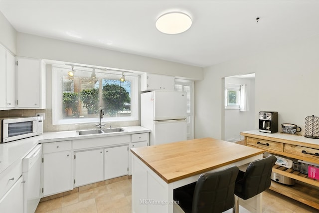 7003 W Carol Ave, Niles, IL 60714 - kitchen featuring white appliances, white cabinets, butcher block counters, and decorative backsplash