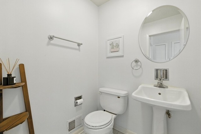 7003 W Carol Ave, Niles, IL 60714 - half bathroom featuring toilet and baseboards
