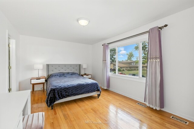 7003 W Carol Ave, Niles, IL 60714 - bedroom with light wood-style flooring and baseboards