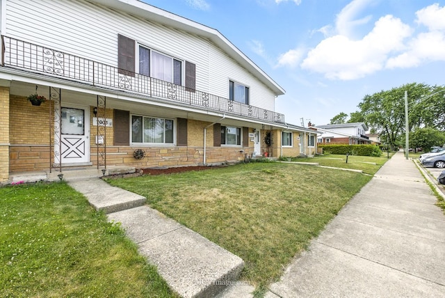 7003 W Carol Ave, Niles, IL 60714 - townhome / multi-family property with brick siding and a front lawn
