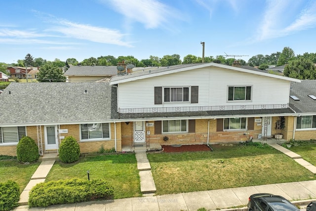 7003 W Carol Ave, Niles, IL 60714 - view of front of property with a front yard, brick siding, and roof with shingles