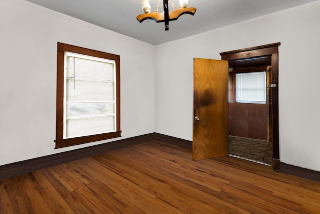 520 Sherman St, Danville, IL 61832 - spare room with a chandelier and wood finished floors