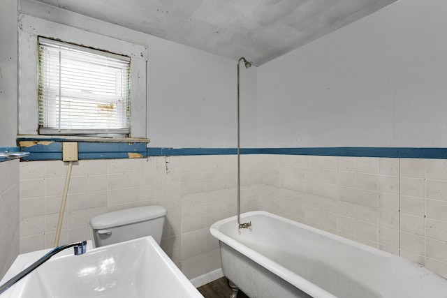 520 Sherman St, Danville, IL 61832 - full bathroom featuring a soaking tub, wainscoting, and tile walls