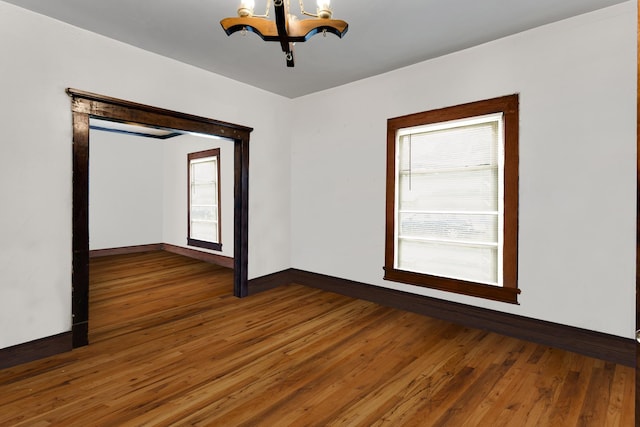 520 Sherman St, Danville, IL 61832 - unfurnished room featuring a chandelier and wood finished floors