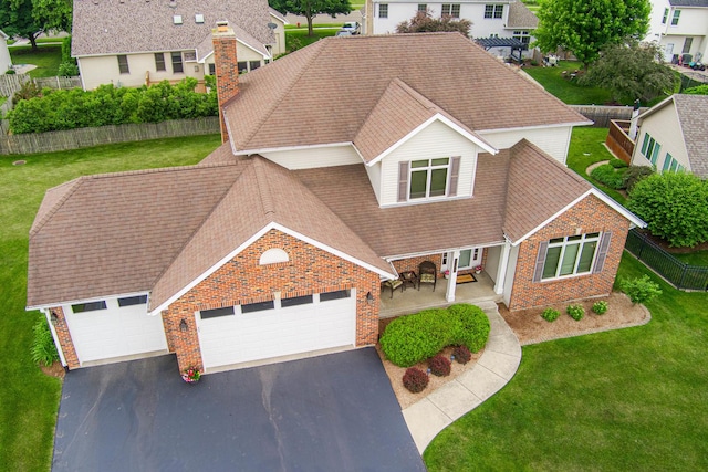 1132 Swanberg Ct, Sycamore, IL 60178 - traditional-style house featuring driveway, a garage, brick siding, and a shingled roof