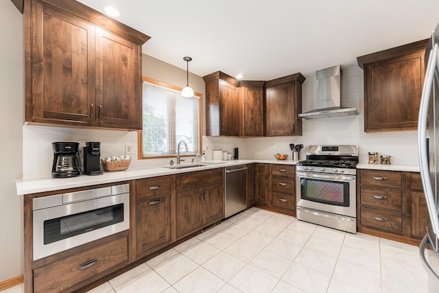 1132 Swanberg Ct, Sycamore, IL 60178 - kitchen with stainless steel appliances, wall chimney range hood, light countertops, dark brown cabinets, and hanging light fixtures