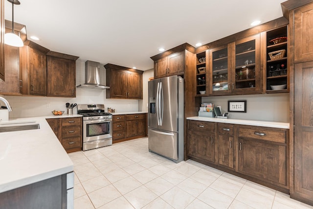 1132 Swanberg Ct, Sycamore, IL 60178 - kitchen with appliances with stainless steel finishes, wall chimney range hood, light countertops, light tile patterned floors, and dark brown cabinetry