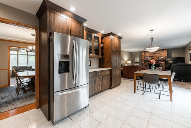 1132 Swanberg Ct, Sycamore, IL 60178 - kitchen with stainless steel refrigerator with ice dispenser, a brick fireplace, open floor plan, glass insert cabinets, and recessed lighting