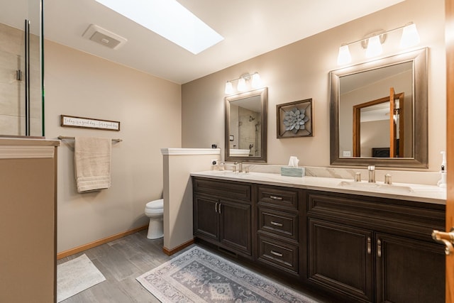 1132 Swanberg Ct, Sycamore, IL 60178 - full bath featuring double vanity, tiled shower, a skylight, and wood finished floors