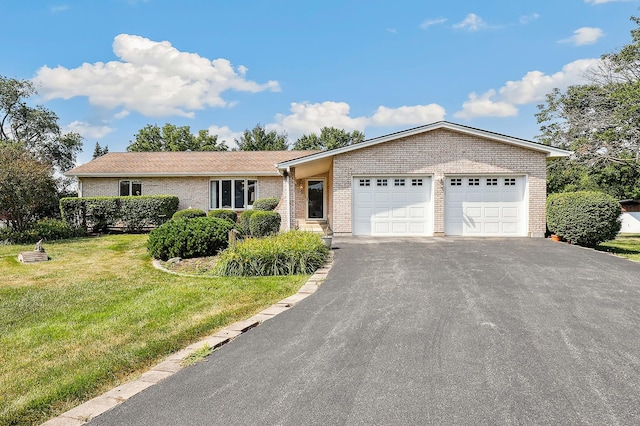 17257 W Rich Ct, Elwood, IL 60421 - ranch-style home with driveway, an attached garage, brick siding, and a front lawn