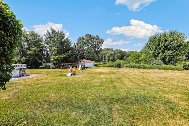17257 W Rich Ct, Elwood, IL 60421 - view of grassy yard featuring a playground, a garage, and an outdoor structure