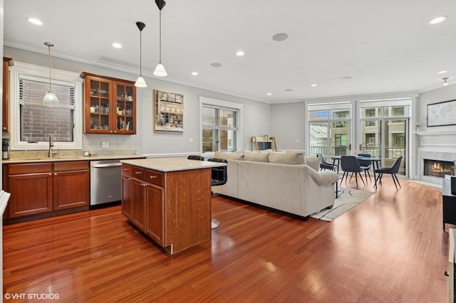 2438 N Clybourn Ave Unit 2, Chicago, IL 60614 - kitchen with stainless steel dishwasher, open floor plan, crown molding, dark wood-style flooring, and brown cabinetry