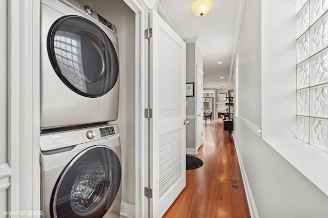 2438 N Clybourn Ave Unit 2, Chicago, IL 60614 - laundry area with estacked washer and dryer, wood finished floors, and recessed lighting