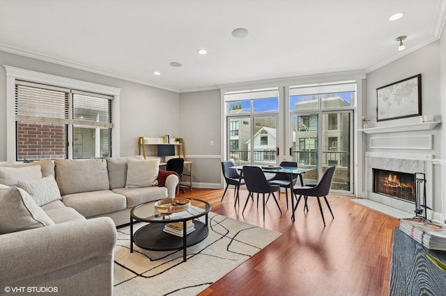 2438 N Clybourn Ave Unit 2, Chicago, IL 60614 - living room featuring ornamental molding, healthy amount of natural light, a high end fireplace, light wood-style flooring, and recessed lighting