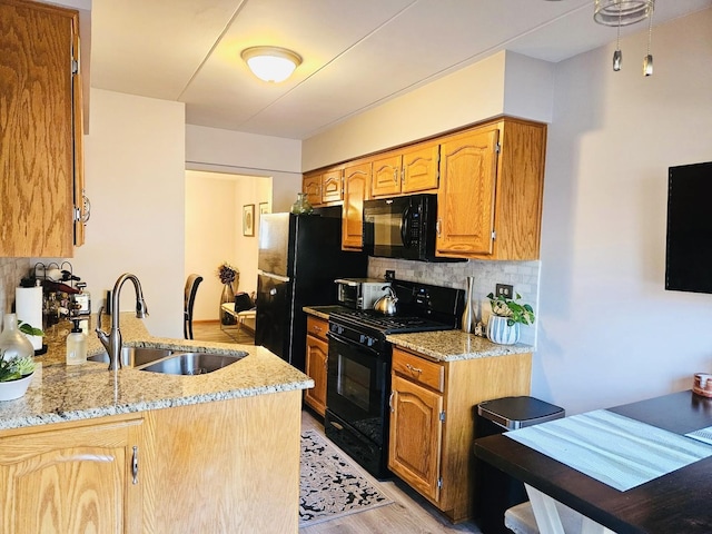 5140 Shadow Creek Dr Unit 1, Oak Forest, IL 60452 - kitchen with black appliances, decorative backsplash, light wood-type flooring, light stone counters, and brown cabinetry