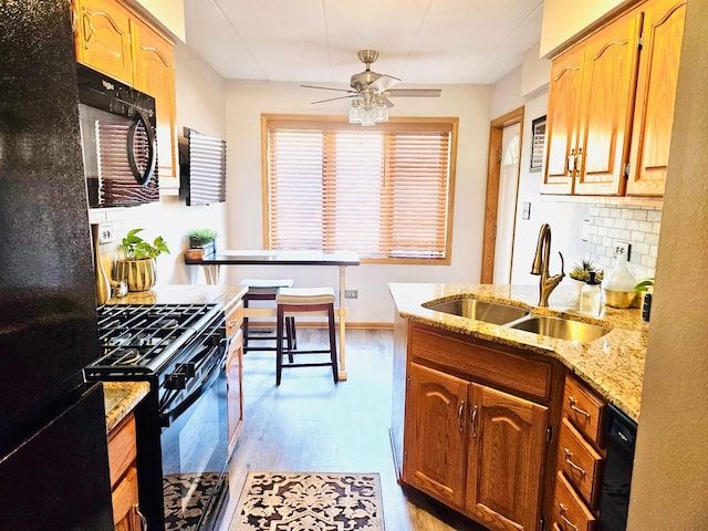 5140 Shadow Creek Dr Unit 1, Oak Forest, IL 60452 - kitchen with black appliances, backsplash, ceiling fan, light wood-style floors, and light stone counters