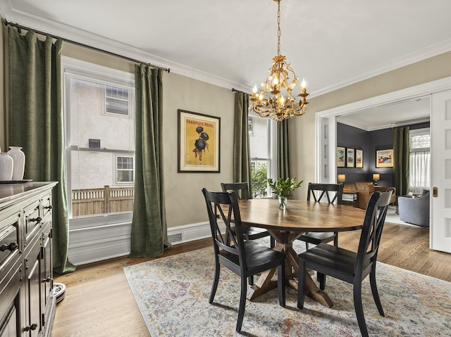 239 7th Ave, La Grange, IL 60525 - dining area with a chandelier, ornamental molding, and light wood-style flooring