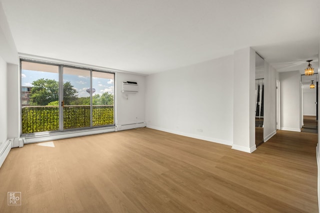 2201 S Stewart Ave Unit 4J, Lombard, IL 60148 - empty room with a wall unit AC, wood finished floors, a chandelier, and a baseboard radiator