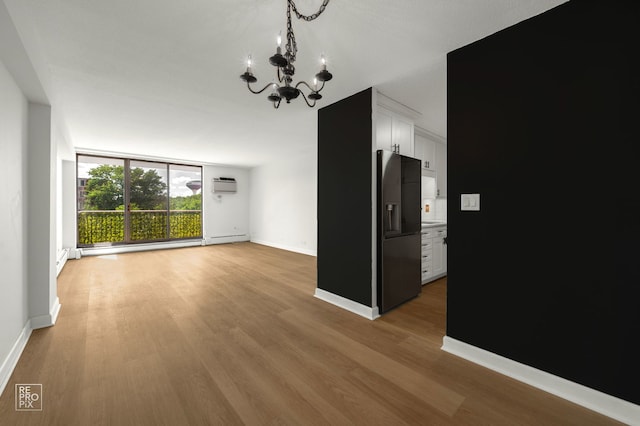 2201 S Stewart Ave Unit 4J, Lombard, IL 60148 - unfurnished dining area featuring a wall mounted air conditioner, a chandelier, wood finished floors, and a baseboard heating unit