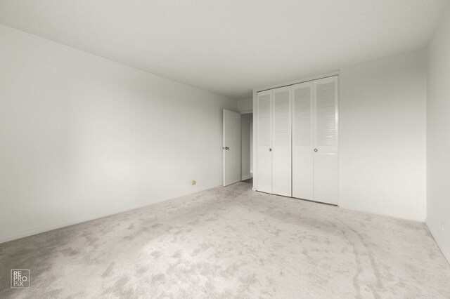 2201 S Stewart Ave Unit 4J, Lombard, IL 60148 - unfurnished bedroom featuring carpet and a closet