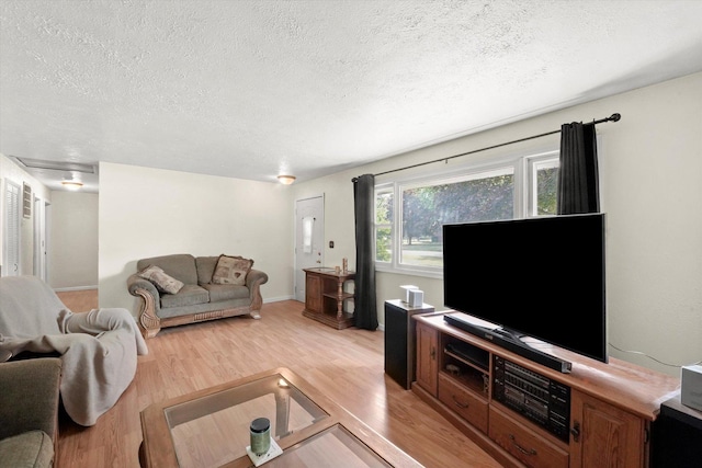 2425 Lockner Blvd, Joliet, IL 60431 - living room with a textured ceiling and light wood-style flooring