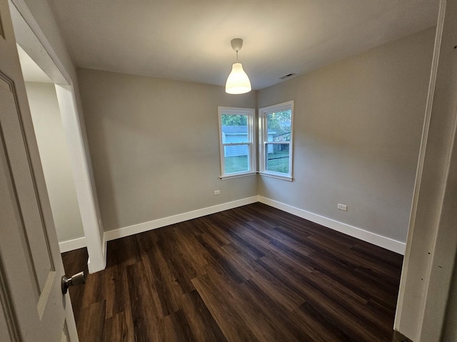 623 Westmoreland Ave, Waukegan, IL 60085 - spare room featuring baseboards and dark wood-style flooring