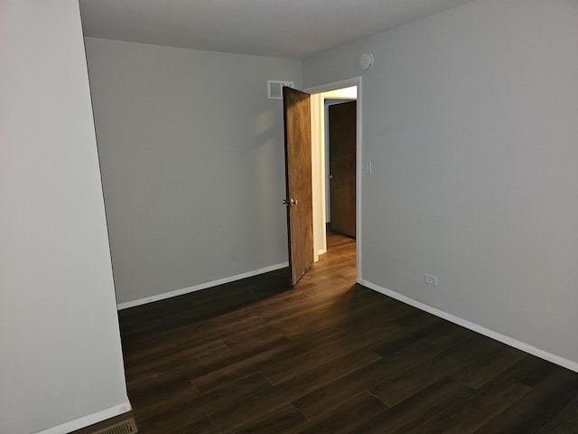 623 Westmoreland Ave, Waukegan, IL 60085 - empty room with dark wood finished floors and a smoke detector