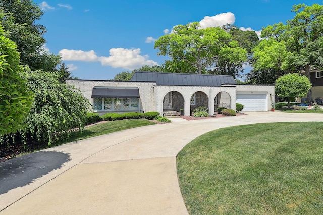 712 Ridge Rd, Lemont, IL 60439 - mediterranean / spanish-style house with driveway, a front yard, brick siding, and a garage