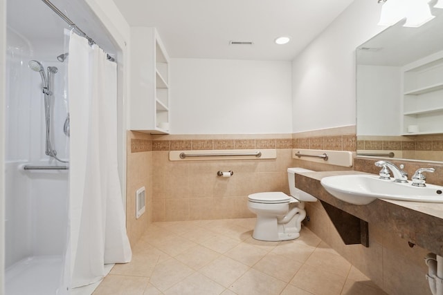 712 Ridge Rd, Lemont, IL 60439 - full bathroom featuring a stall shower, wainscoting, tile patterned flooring, and tile walls