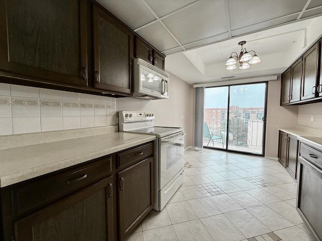 555 Graceland Ave Unit 505, Des Plaines, IL 60016 - kitchen with white appliances, a chandelier, dark brown cabinetry, and light countertops