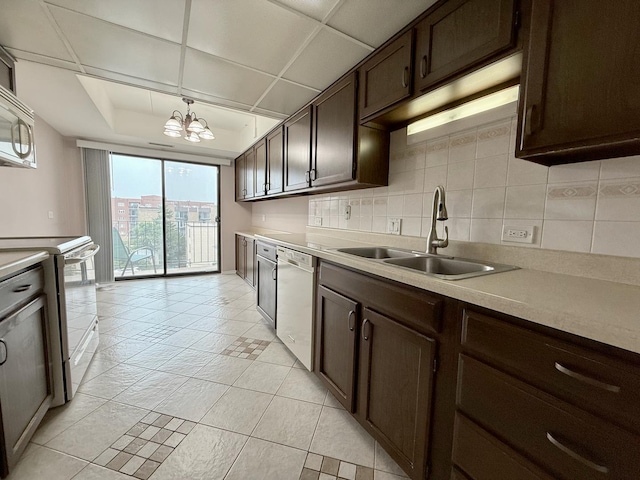 555 Graceland Ave Unit 505, Des Plaines, IL 60016 - kitchen with white appliances, dark brown cabinetry, tasteful backsplash, and light countertops