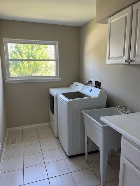 1312 Strawbridge Ct, Naperville, IL 60565 - laundry room featuring cabinet space, washing machine and dryer, and light tile patterned floors
