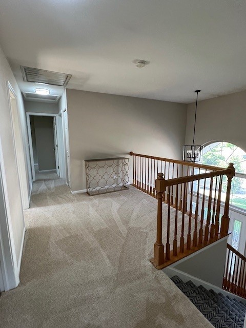 1312 Strawbridge Ct, Naperville, IL 60565 - corridor featuring carpet floors, an upstairs landing, a chandelier, and attic access