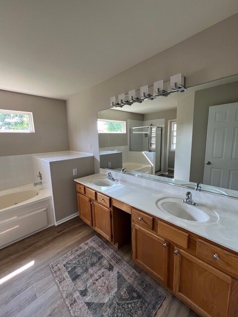 1312 Strawbridge Ct, Naperville, IL 60565 - full bath with wood finished floors, a garden tub, double vanity, and a stall shower