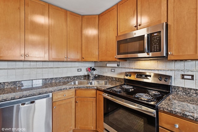 7428 Washington St Unit 508, Forest Park, IL 60130 - kitchen featuring stainless steel appliances, dark stone counters, and decorative backsplash