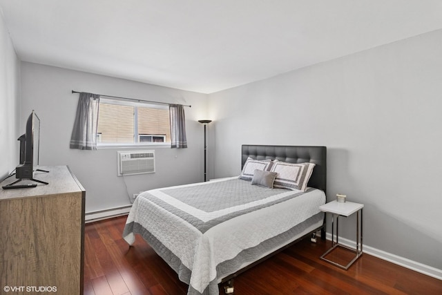 7428 Washington St Unit 508, Forest Park, IL 60130 - bedroom with a baseboard heating unit, a wall mounted AC, and wood finished floors