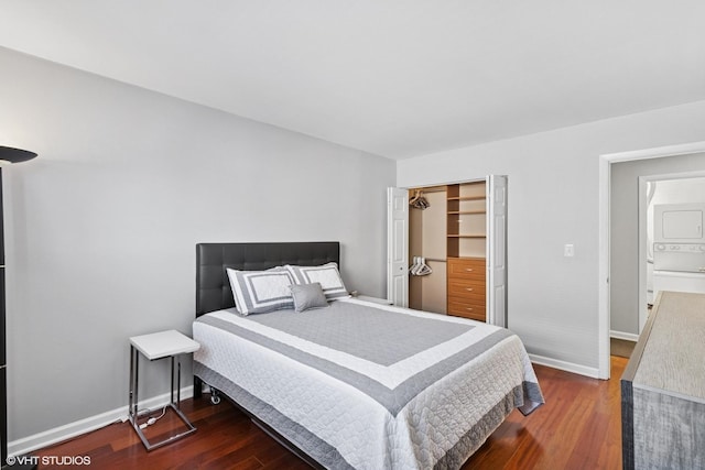 7428 Washington St Unit 508, Forest Park, IL 60130 - bedroom with stacked washer / drying machine, dark wood-style flooring, and a closet