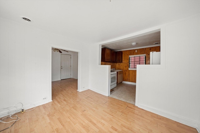 2142 N Mobile Ave, Chicago, IL 60639 - unfurnished living room featuring light wood finished floors and wood walls