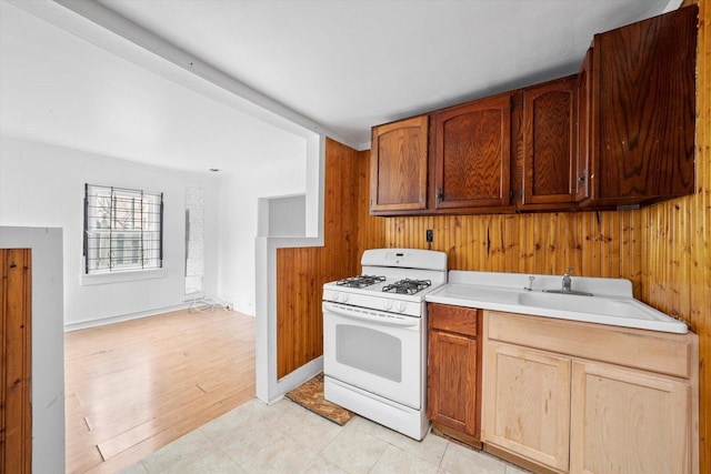2142 N Mobile Ave, Chicago, IL 60639 - kitchen featuring gas range gas stove, light countertops, and wooden walls