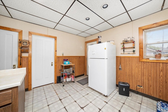 2142 N Mobile Ave, Chicago, IL 60639 - kitchen featuring freestanding refrigerator, a wainscoted wall, wooden walls, a paneled ceiling, and light flooring